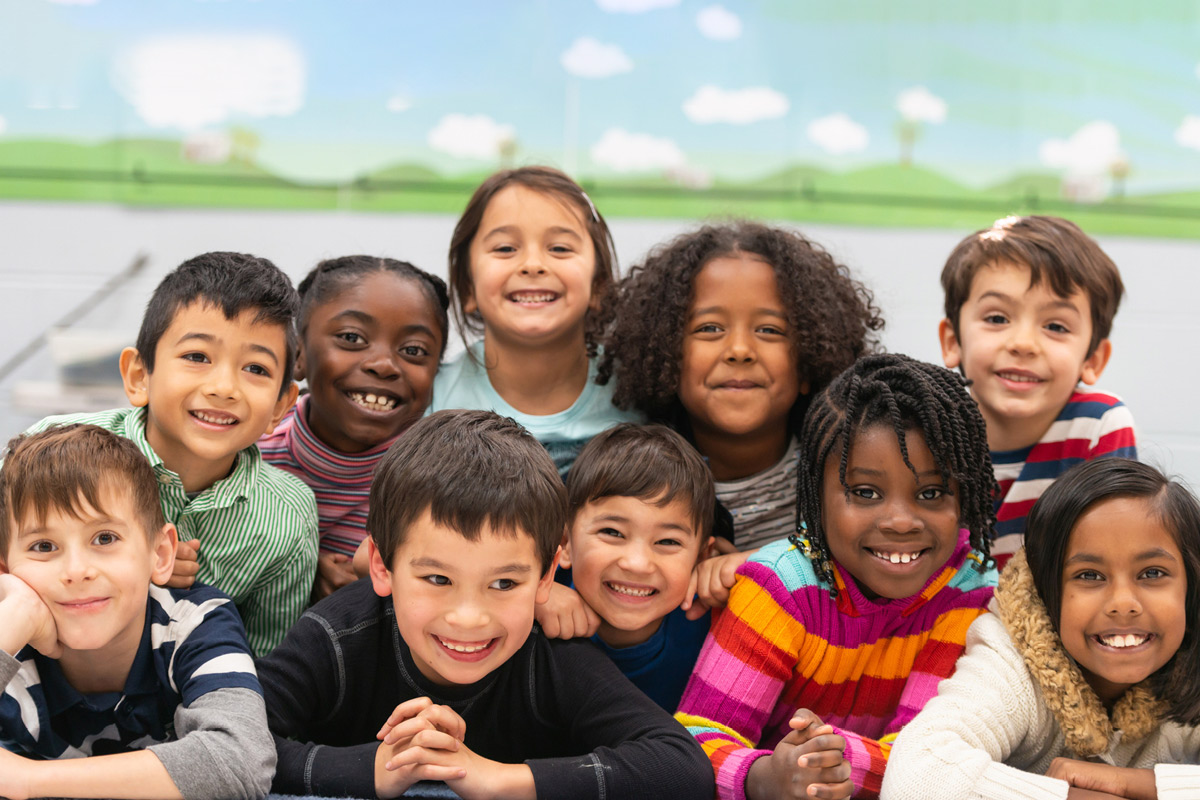 group of smiling young children, both genders many races