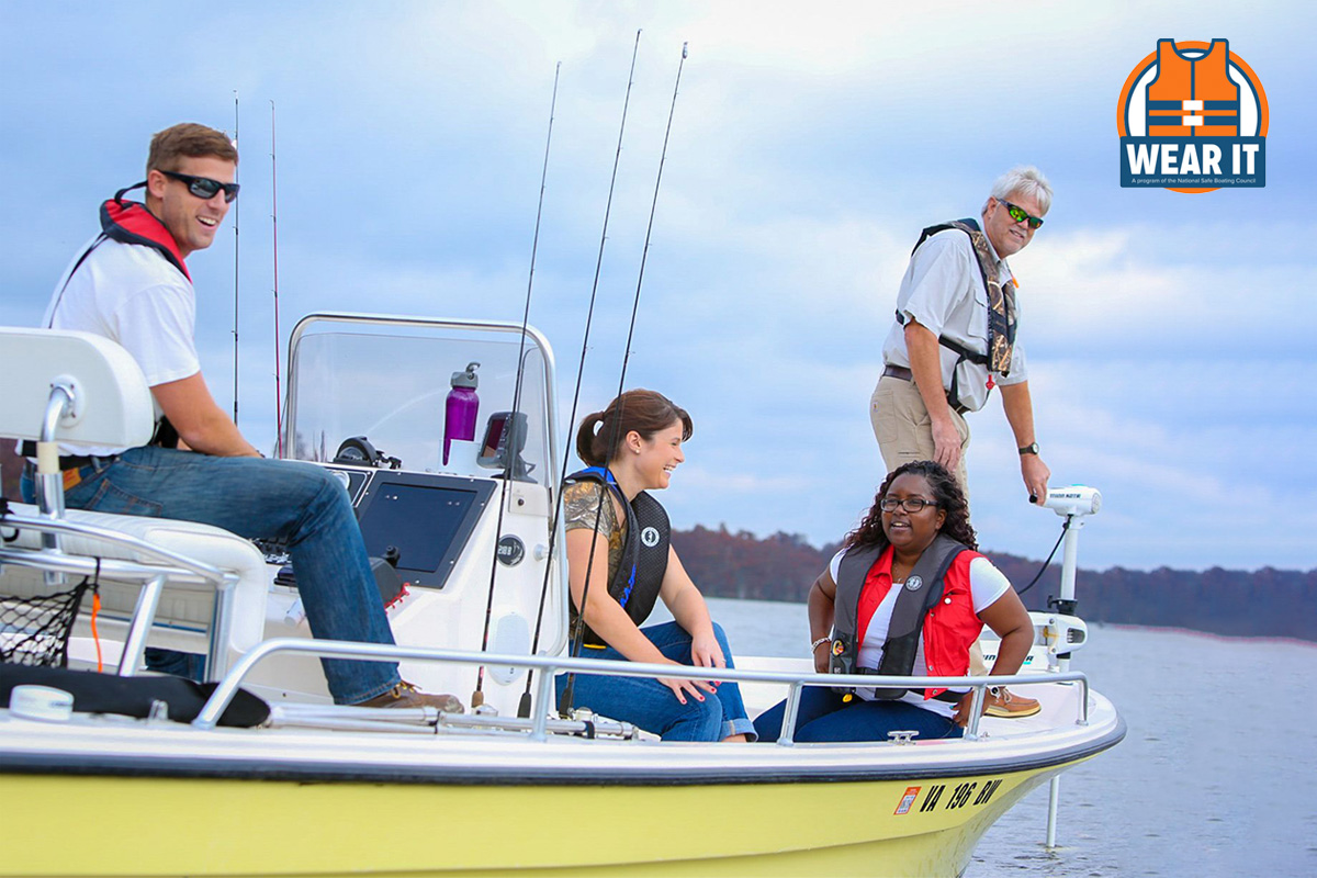 4 people wearing life jackets in a fishing boat
